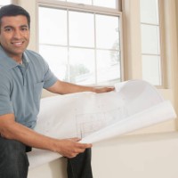 hispanic man reading blueprints in new home - home decoration stock pictures, royalty-free photos & images