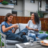 hispanic mother and son eating pizza outdoors - junk food stock pictures, royalty-free photos & images