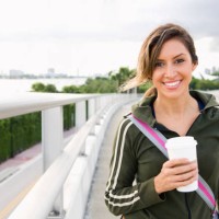 hispanic woman walking outdoors with coffee - junk food stock pictures, royalty-free photos & images