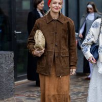 Hollie Mercedes Peters wears red head scarf, brown suede skirt, jacket, beige Bottega Veneta bag outside Munthe during the Copenhagen Fashion Week...