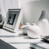 home decoration of neutral coloured vases and picture frame on a cabinet by the window in sunlight - home decoration stock pictures, royalty-free photos & images