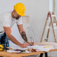 home diy, mature man working as carpenter underlining part of blueprint using pencil - home decoration stock pictures, royalty-free photos & images