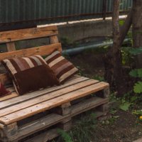homemade bench from pallets with cushions in the yard - garden decoration stock pictures, royalty-free photos & images