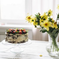 homemade cake with berries and mint leaves on dining table with bouquet of garden flowers at home - garden decoration stock pictures, royalty-free photos & images