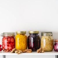 homemade pickled vegetables in jars on shelf at home - food stock pictures, royalty-free photos & images