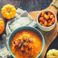 homemade pumpkin cream soup with baked pumpkin pieces in a bowl - food stock pictures, royalty-free photos & images
