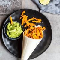 homemade sweet potato fries and bowl of guacamole - junk food stock pictures, royalty-free photos & images