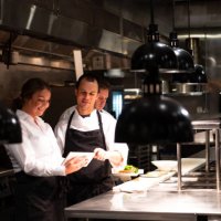hospitality team discussing bookings on a tablet - food stock pictures, royalty-free photos & images
