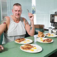 hostile man with plates of fried food - junk food stock pictures, royalty-free photos & images