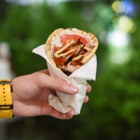 human hand holding deletions gyro pita - junk food stock pictures, royalty-free photos & images