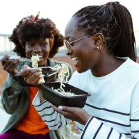 hungry female friends - junk food stock pictures, royalty-free photos & images