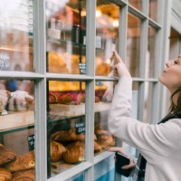 hungry woman at the bakery - junk food stock pictures, royalty-free photos & images