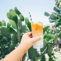 iced latte in glass with straw in woman hand. - junk food stock pictures, royalty-free photos & images