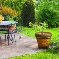 idyllic garden patio, table and chairs, flower pots - garden decoration stock pictures, royalty-free photos & images