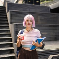 image of young woman with colorful hair on university campus and holding sustainable coffee cup - fashion stock pictures, royalty-free photos & images