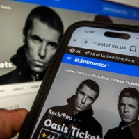 In this photo illustration a laptop and a smart phone displays the Ticketmaster website on September 8, 2024 in Bath, England. The UK's Competition...
