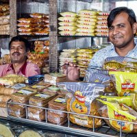 India Mumbai Apollo Bandar Colaba Causeway Market Shahid Bhagat Singh Marg snacks junk food sale display man coworkers.