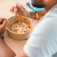 indian male eating take out in corporate office - junk food stock pictures, royalty-free photos & images