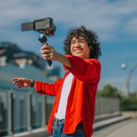 influencer asian malay generation z young man vlogging in kuala lumpur city street sidewalk looking at camera - fashion stock pictures, royalty-free photos & images