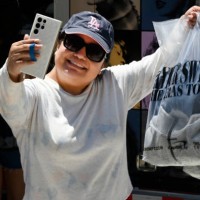 Inglewood, CA Ale Ramirez takes a proud selfie of her Taylor Swift merchandise at SoFi Stadium in Inglewood on Wednesday, August 2, 2023. The Eras...