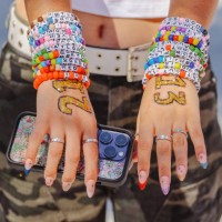 Inglewood, CA Taylor Swift fan Emma Sadeghi, of Glendale, shows her friendship bracelets as she arrives at the emporarily renamed 