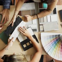 interior designer discussing tile and color options with clients in her office - home decoration stock pictures, royalty-free photos & images
