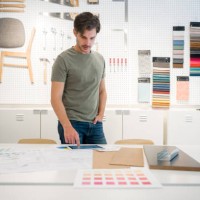 interior designer looking at pictures on his tablet at the office - home decoration stock pictures, royalty-free photos & images