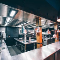 interior of illuminated commercial kitchen in restaurant - home decoration stock pictures, royalty-free photos & images