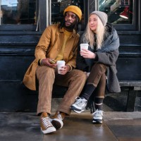 interracial couple enjoying coffee outdoors - fashion stock pictures, royalty-free photos & images