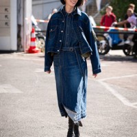 Irene Kim wears a blue denim shirt, blue denim jacket, denim midi skirt and black boots, outside Sacai, during the Womenswear Spring/Summer 2024 as...