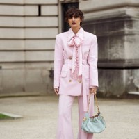 Irina Kro Eicke wears pink suit, wide pants and blazer with a belt and bow tie and mint green bag outside the Zimmermann fashion show during the...