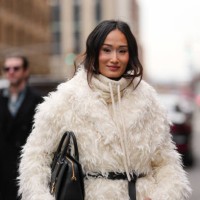 Isabel Tan wears cream Michael Kors hoodie, cream faux fur oversized Michael Kors coat, shiny black Michael Kors leather belt, shiny black Michael...