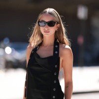 Isabelle Allain is seen wearing black angular cat-eye shaped sunglasses from the Gentle Monster x Jentle Salon collection; small silver hoop...
