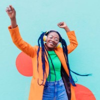 italy, milan, stylish woman with headphones dancing against wall - fashion stock pictures, royalty-free photos & images
