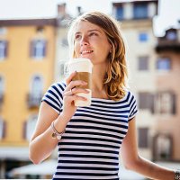 italy, udine, portrait of smiling young woman with coffee to go - junk food stock pictures, royalty-free photos & images