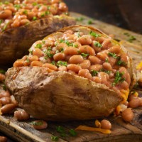 jacket potatoes with baked beans - junk food stock pictures, royalty-free photos & images