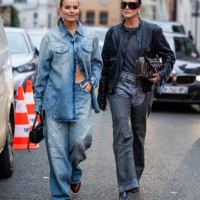 Janka Polliani wears denim shirt, jeans & Darja Barannik wears black jacket, jeans, brown bag outside Acne during the Womenswear Fall/Winter...