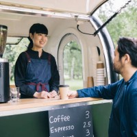 japanese customer and mobile coffee trailer owner having a chat - junk food stock pictures, royalty-free photos & images