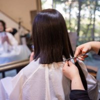 japanese woman cutting hair for hair donation - hairstyle stock pictures, royalty-free photos & images
