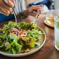 japanese woman eating a vegan lunch at a vegan cafe - food stock pictures, royalty-free photos & images