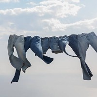 jeans hanging on a clothesline in the wind - fashion stock pictures, royalty-free photos & images