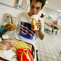 Jeff Baughman takes a sip of his Super Coke as he eats his Double Quarterpounder with cheese along with a Super Fry on July 18, 2002 at a McDonalds...