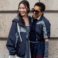 Jenny Tsang wears grey jacket, wrapped jumper & Tamu McPherson wears jackets, gauntlets, sunglasses outside Miu Miu during the Womenswear Fall/Winter...