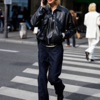 Jessie Andrews wears black leather jacket, navy pants, sunglasses outside Magda Butrym presentation during the Womenswear Fall/Winter 2025/2026 as...