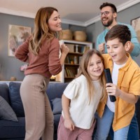 joyful karaoke singing with family at home - concert stock pictures, royalty-free photos & images