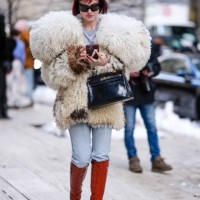Julia Hobbs wears black sunglasses, light gray t-shirt, faux fur Alexander Mcqueen coat, shiny black Hermes Kelly leather shoes, light blue skinny...