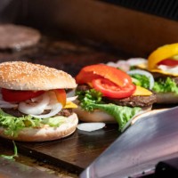 July 2023, Baden-Württemberg, Rottweil: Burgers are prepared at a food stand at an event in Rottweil. Photo: Silas Stein/dpa