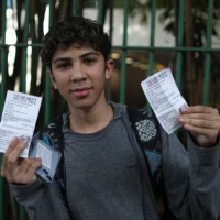 June 2023, Brazil, São Paulo: A boy shows the tikets just bought at the Allianz Parque stadium for 