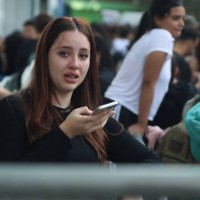 June 2023, Brazil, São Paulo: A young woman cries in front of the Allianz Parque stadium because she did not get tickets for 