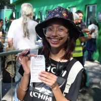 June 2023, Brazil, São Paulo: A young woman shows a tiket just bought at the Allianz Parque stadium for 